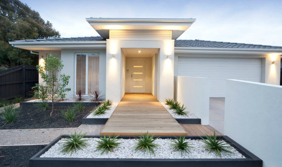 Minimalistic white Front Yard Landscaping using pebble and Small plants 