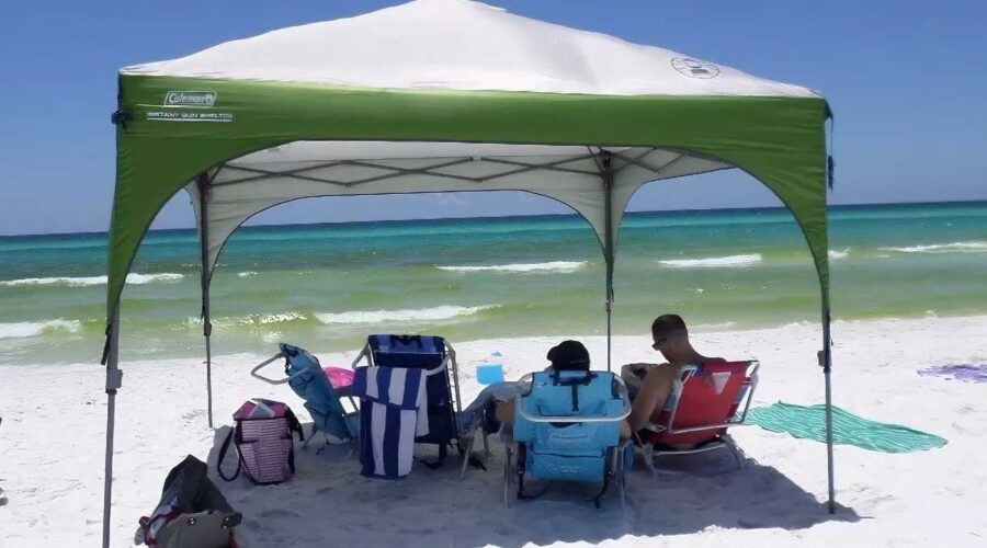 blue sky, the beach boasts the best beach shade—a remarkable green and white tent known as the Coleman Instant Eaved Shelter.