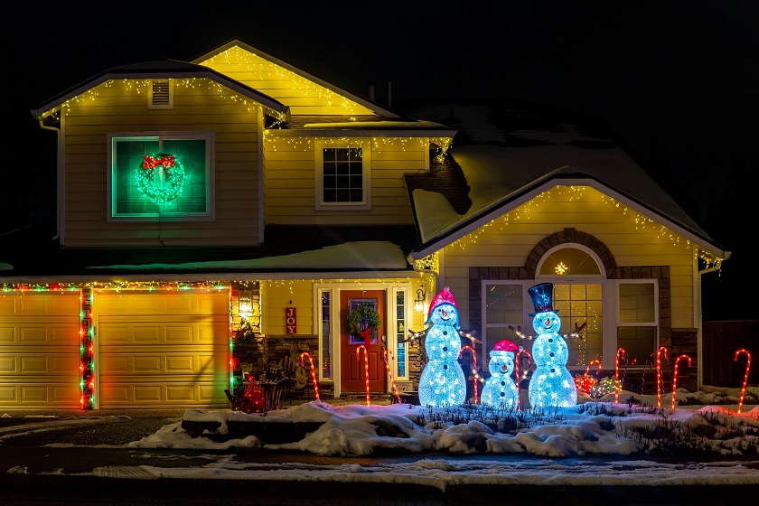 Front yard Christmas Light Decorations With inflatable santa and Light Wreath in Window