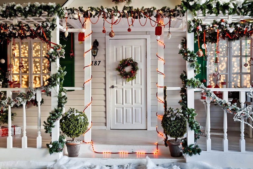 White Front Door with wreath and Light Around Walkway Christmas Decorations
