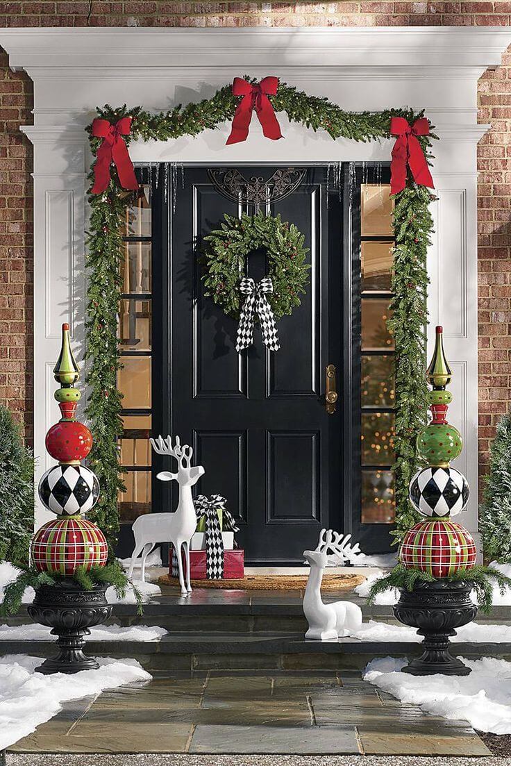 Black Front Porch Decoration with Reindeer Promp and Wreath with Garland.