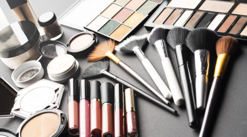 Multiple cosmetic products on black background.