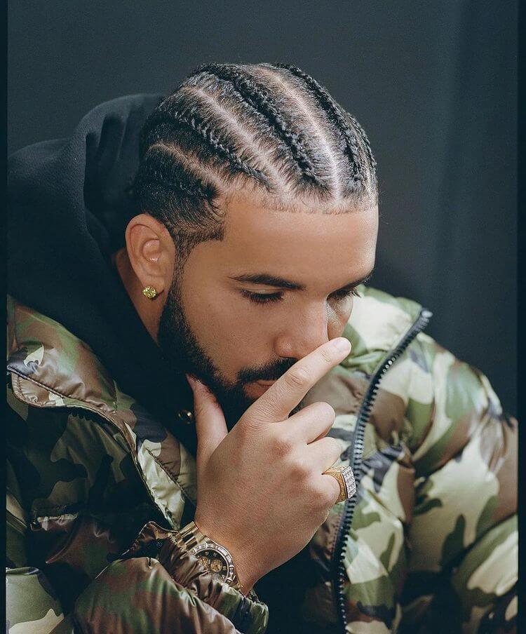 A man drake singer with dreadlocks showcasing dreadlock hairstyle styles for men.