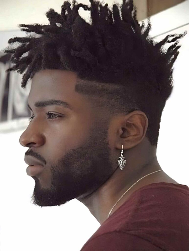 A man with Zoomed face showing his Classic Dreadlocks wearing a red shirt.