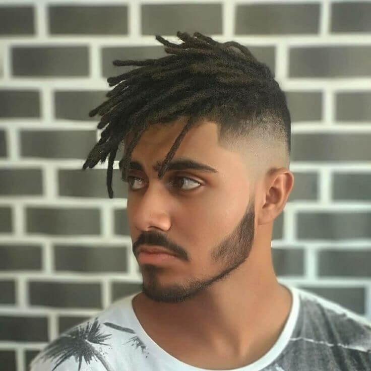 Dreadlocks with undercut for men with Fade in Side with Black and white Bricks Background. Zoomed face