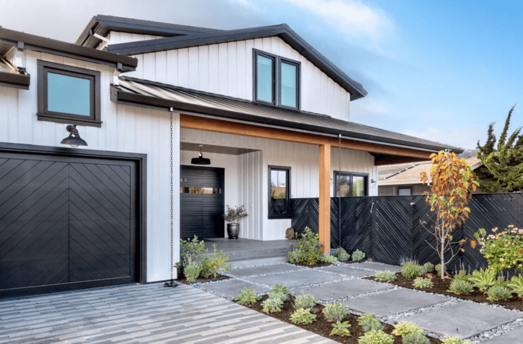 Black and white contemporary house Exterior with black Garage Door