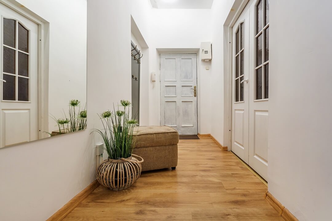 Corridor Design of White House with white wall and Wooden Flooring