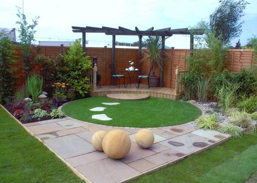 sustainable modern garden design stone in front sitting area in back and round gardern with walking area
