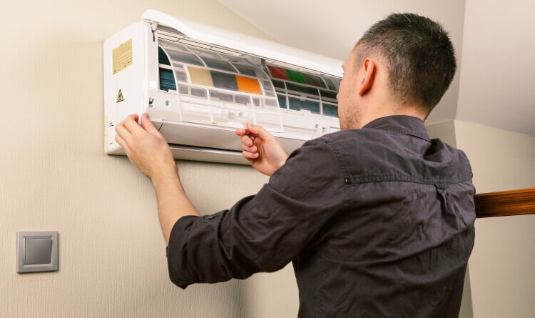 Men Cleaning and maintain his AC also HVAC repair at home