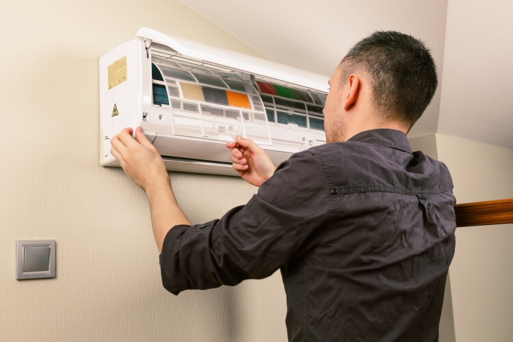 Men Cleaning and maintain his AC also HVAC repair at home