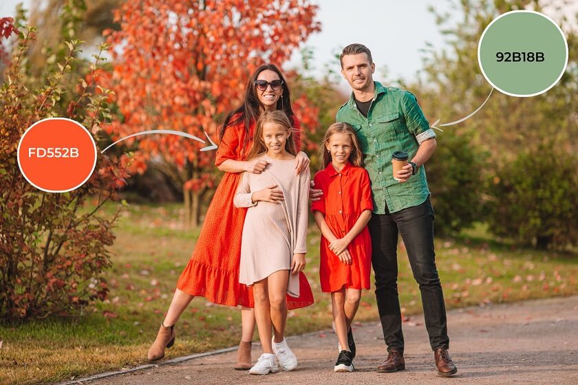 family wearing rustic fall tone outfit in front of park