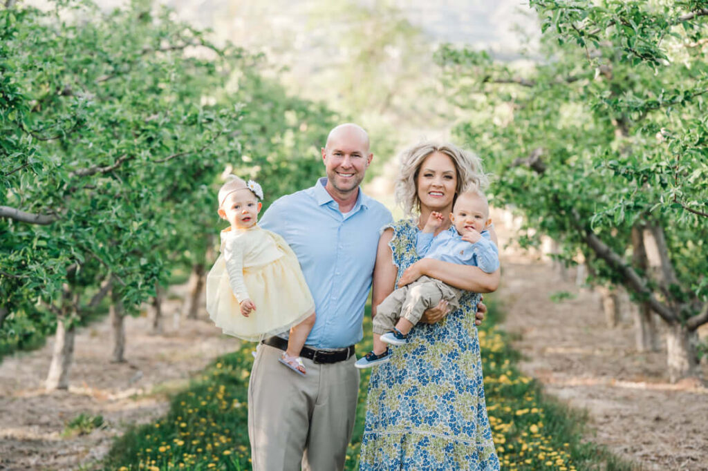 Orchards with apple trees offer a rustic charm to family with proper pose and Outfit
