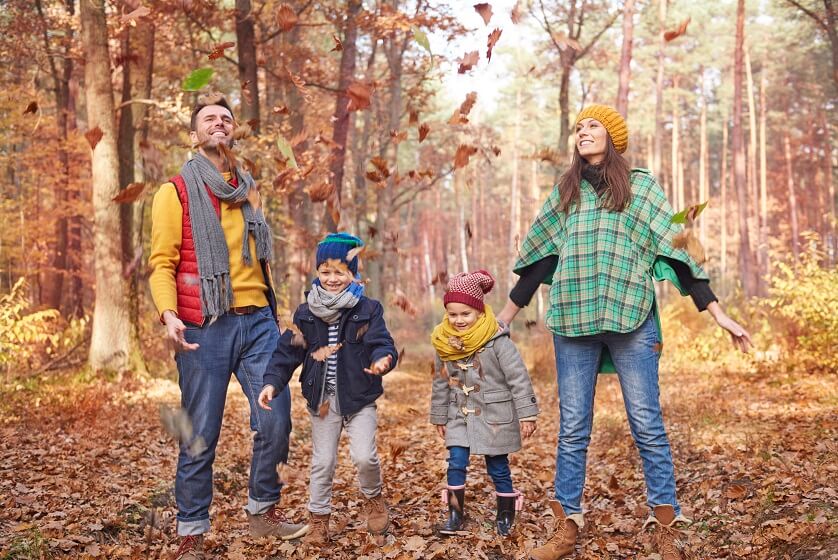 family Candid image while playing with fall leafs