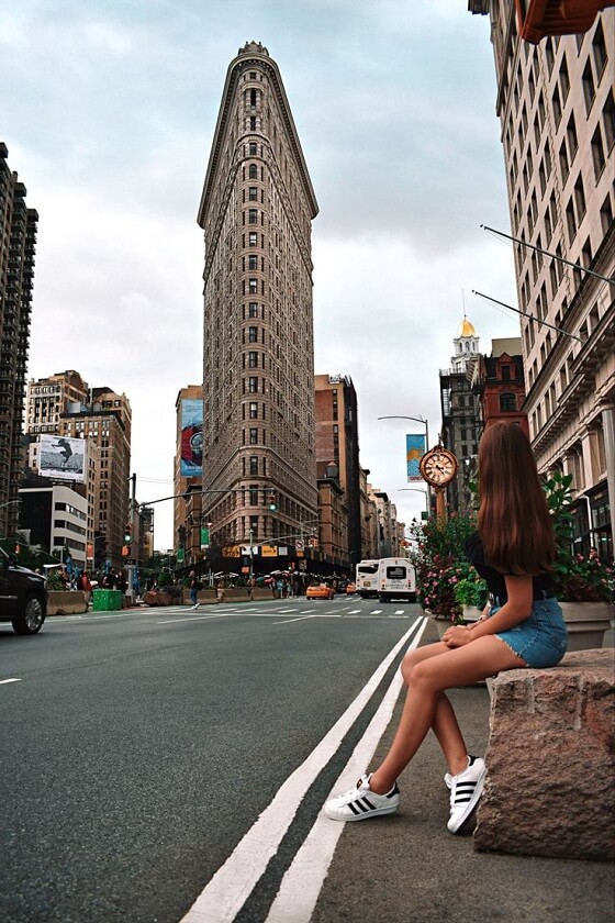 Girl Sitting in Stone Chair near the Flatiron Building