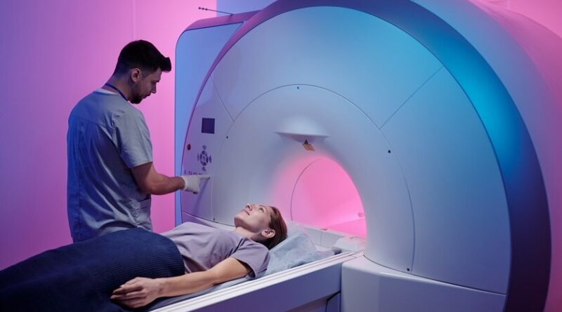 young doctor pushing button panel start mri scan procedure