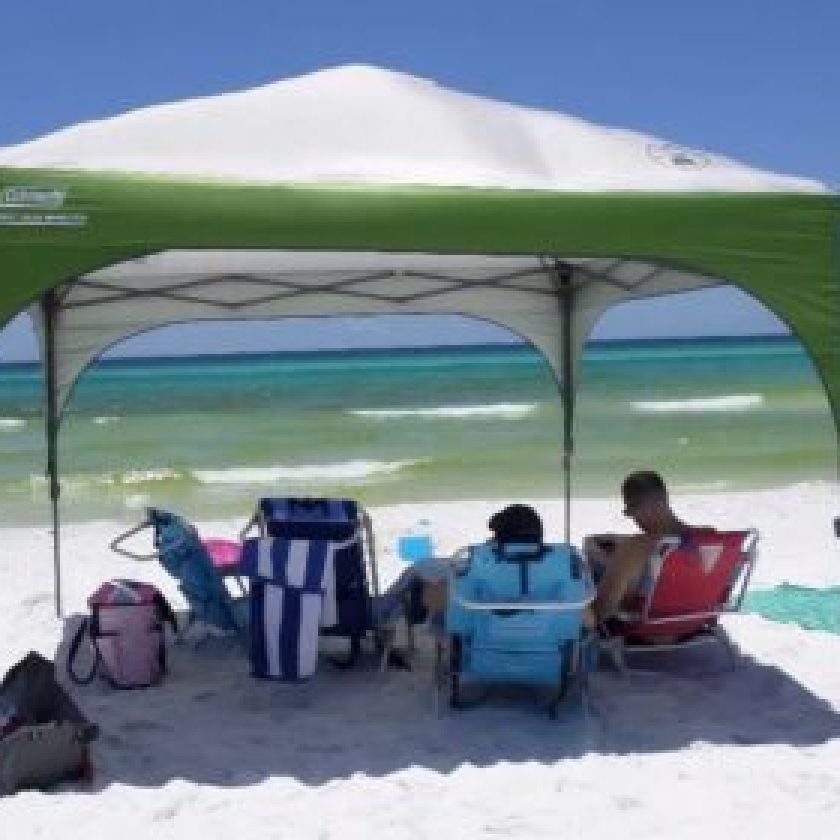 blue sky, the beach boasts the best beach shade—a remarkable green and white tent known as the Coleman Instant Eaved Shelter.