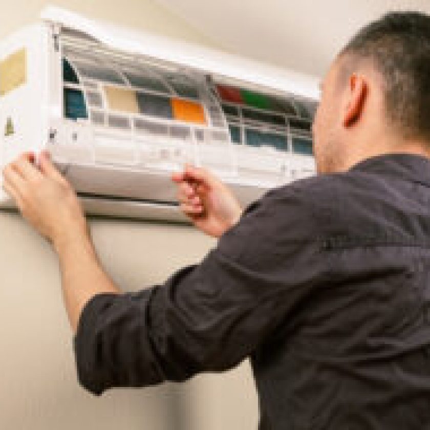 Men Cleaning and maintain his AC also HVAC repair at home