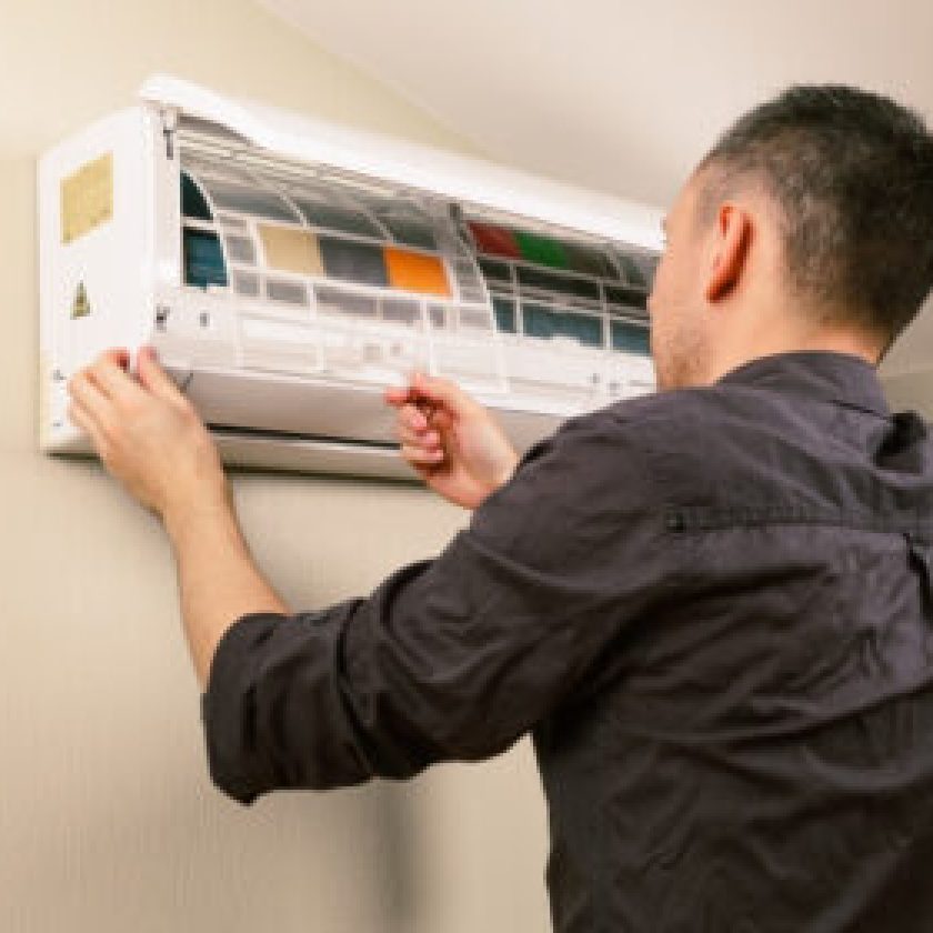 Men Cleaning and maintain his AC also HVAC repair at home