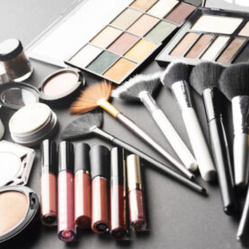 Multiple cosmetic products on black background.