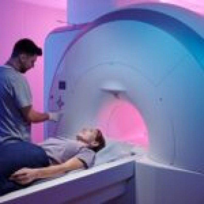 young doctor pushing button panel start mri scan procedure