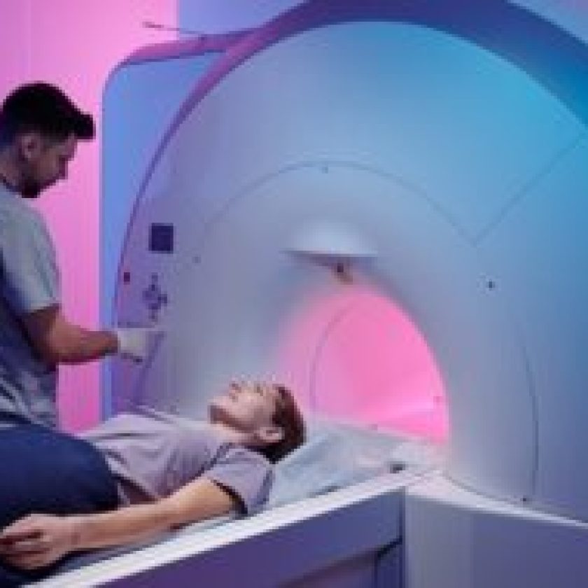 young doctor pushing button panel start mri scan procedure